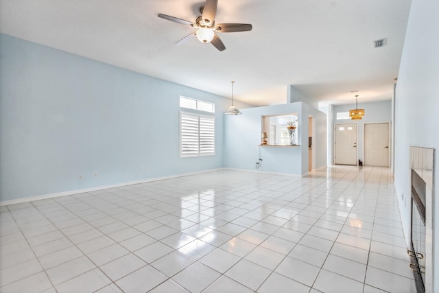 unfurnished living room with ceiling fan and light tile patterned flooring