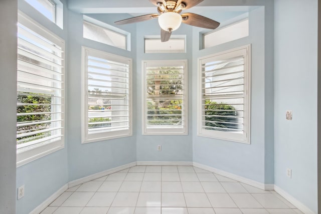 unfurnished room with ceiling fan and light tile patterned floors