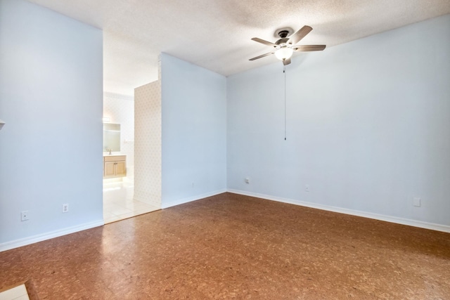 spare room featuring ceiling fan, sink, and a textured ceiling