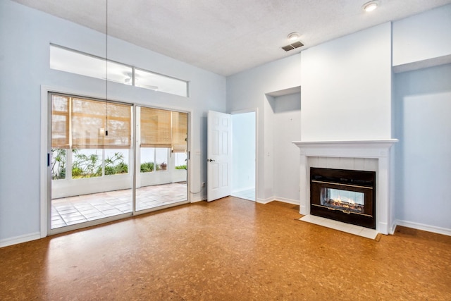 unfurnished living room featuring a fireplace and a textured ceiling