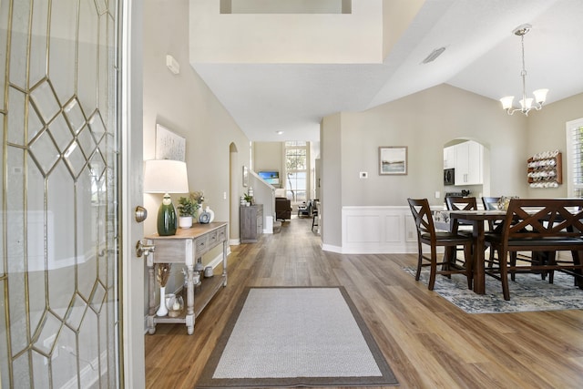 1125 S Marsh Wind Way, Ponte Vedra Beach, FL 32082 - foyer entrance with arched walkways, a wainscoted wall, light wood-type flooring, and visible vents