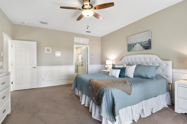 1125 S Marsh Wind Way, Ponte Vedra Beach, FL 32082 - bedroom featuring visible vents, wainscoting, ensuite bathroom, ceiling fan, and carpet flooring