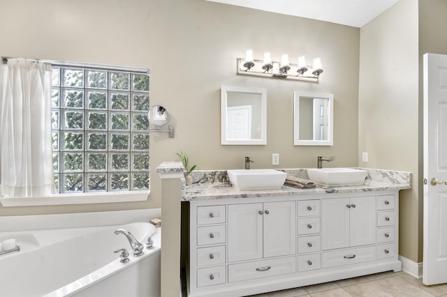 1125 S Marsh Wind Way, Ponte Vedra Beach, FL 32082 - bathroom featuring a sink, tile patterned flooring, double vanity, and a bath