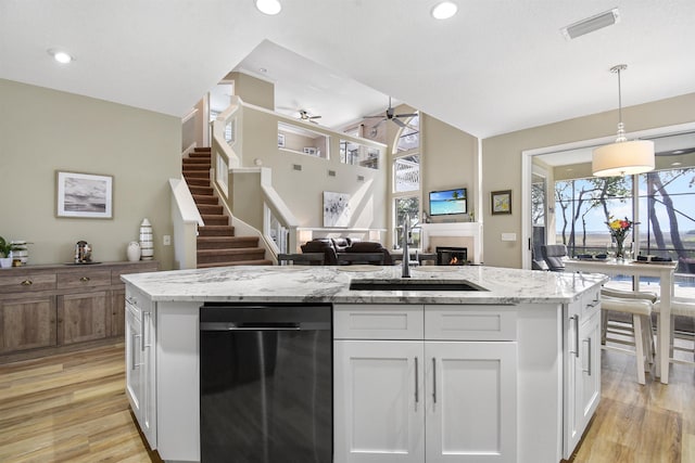 1125 S Marsh Wind Way, Ponte Vedra Beach, FL 32082 - kitchen featuring ceiling fan, a sink, white cabinets, light wood finished floors, and dishwashing machine