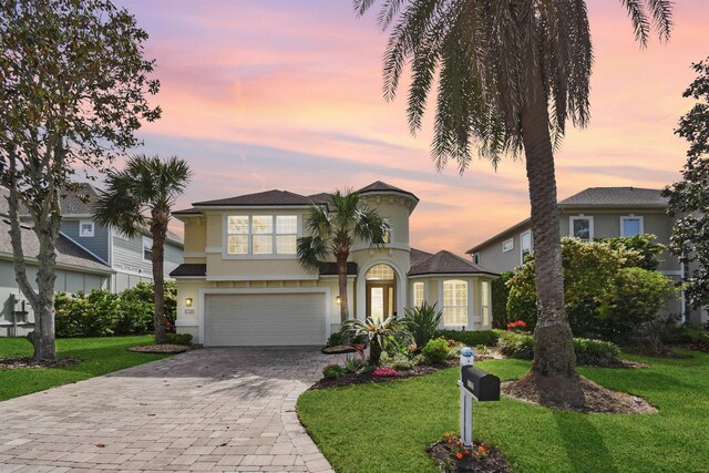 1125 S Marsh Wind Way, Ponte Vedra Beach, FL 32082 - view of front facade featuring stucco siding, an attached garage, decorative driveway, and a front yard