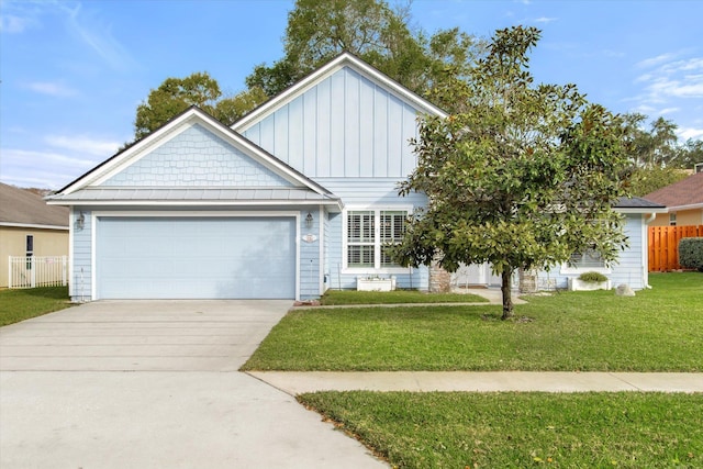 view of front of property featuring a garage and a front lawn