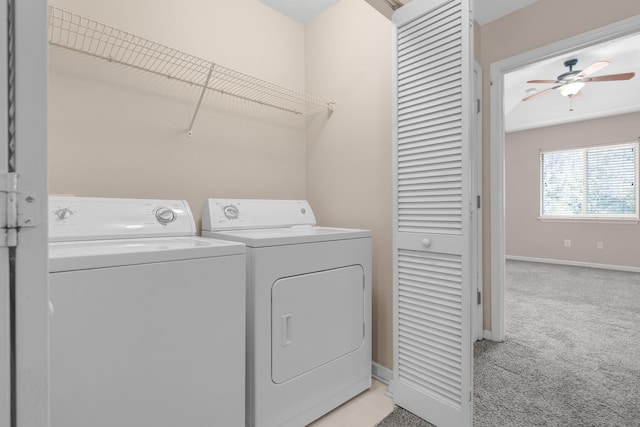 clothes washing area with light colored carpet, washer and clothes dryer, and ceiling fan