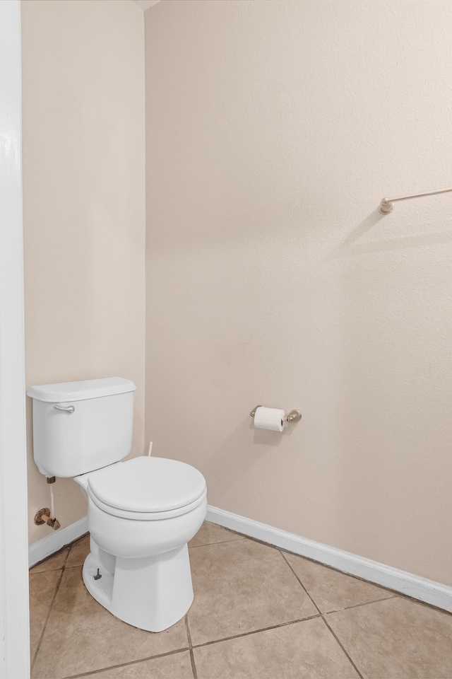 bathroom featuring tile patterned flooring and toilet