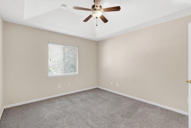 carpeted spare room with ceiling fan