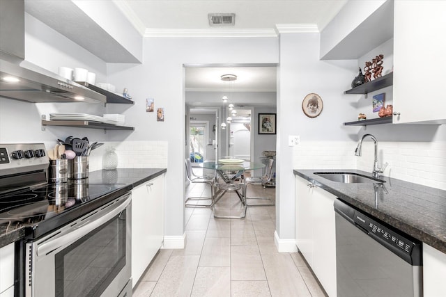 317 Flagler Blvd Unit 3A, Saint Augustine, FL 32080 - kitchen with stainless steel appliances, open shelves, wall chimney range hood, ornamental molding, and white cabinetry