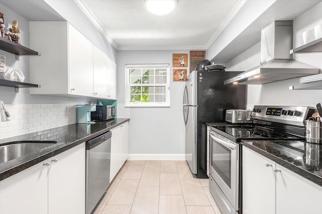 317 Flagler Blvd Unit 3A, Saint Augustine, FL 32080 - kitchen featuring appliances with stainless steel finishes, wall chimney exhaust hood, open shelves, tasteful backsplash, and white cabinetry