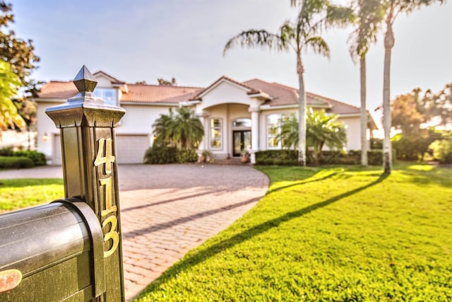 413 Fiddlers Point Dr, Saint Augustine, FL 32080 - mediterranean / spanish-style home with driveway, a front lawn, a garage, a tiled roof, and french doors