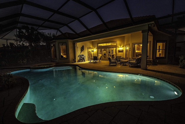413 Fiddlers Point Dr, Saint Augustine, FL 32080 - pool at twilight with a patio area, glass enclosure, and a pool with connected hot tub