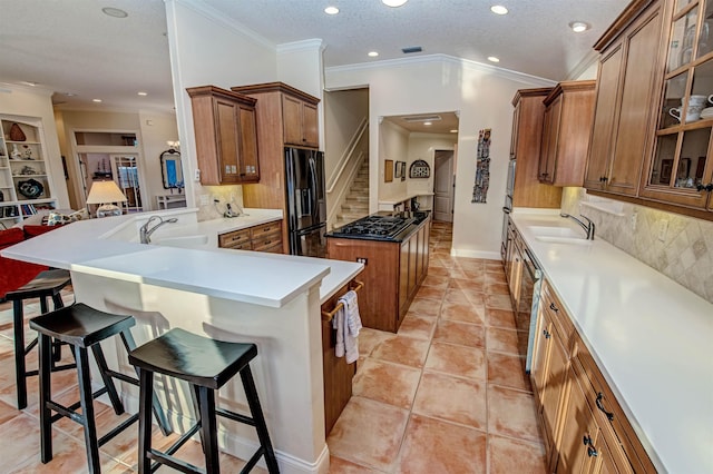 413 Fiddlers Point Dr, Saint Augustine, FL 32080 - kitchen featuring black refrigerator with ice dispenser, a sink, a kitchen island, recessed lighting, and brown cabinetry
