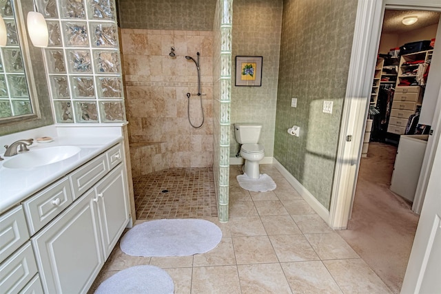 413 Fiddlers Point Dr, Saint Augustine, FL 32080 - full bathroom featuring walk in shower, vanity, tile patterned flooring, toilet, and a walk in closet