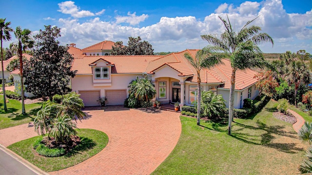 413 Fiddlers Point Dr, Saint Augustine, FL 32080 - mediterranean / spanish-style house with a tiled roof, decorative driveway, stucco siding, and a front yard