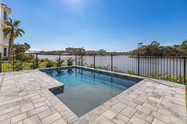 view of swimming pool with a water view, a patio area, a fenced backyard, and a fenced in pool