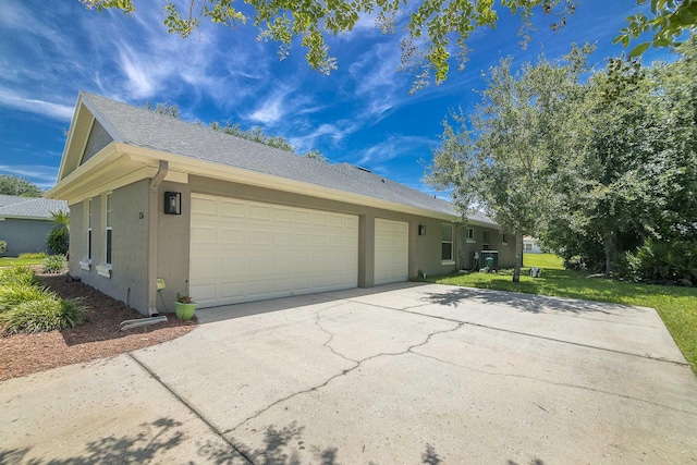 exterior space featuring central AC, a garage, and a front lawn