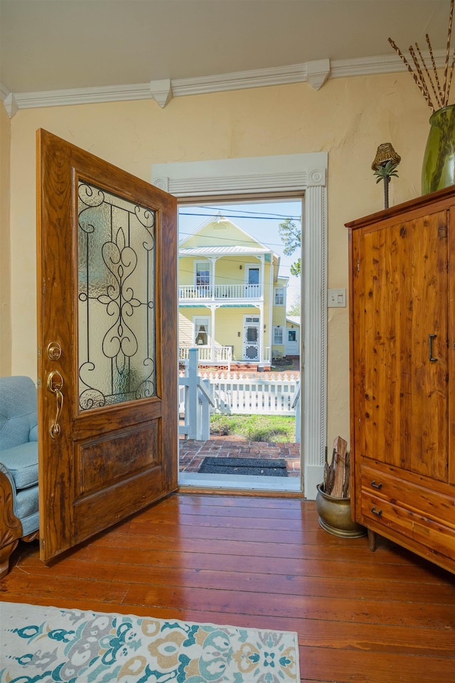 entrance foyer featuring hardwood / wood-style floors and crown molding