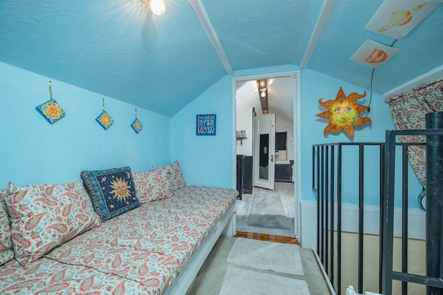 carpeted bedroom with a textured ceiling and lofted ceiling