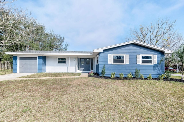 ranch-style house featuring a garage and a front lawn