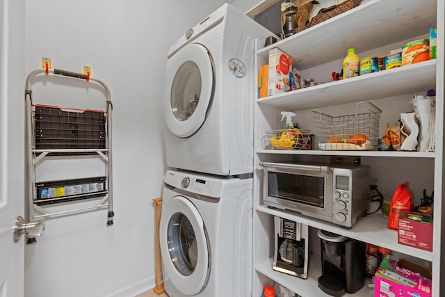 laundry room with stacked washer / drying machine