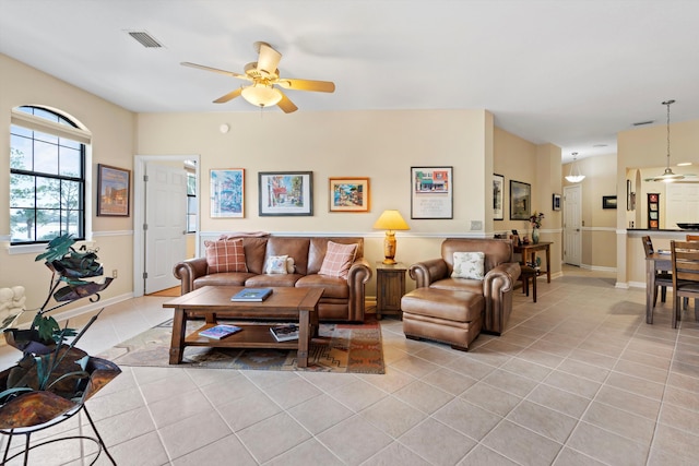 living room with ceiling fan and light tile patterned flooring