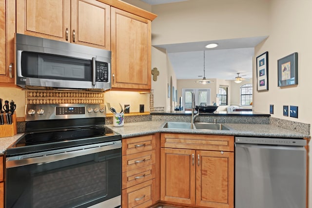 kitchen with ceiling fan, stainless steel appliances, and sink