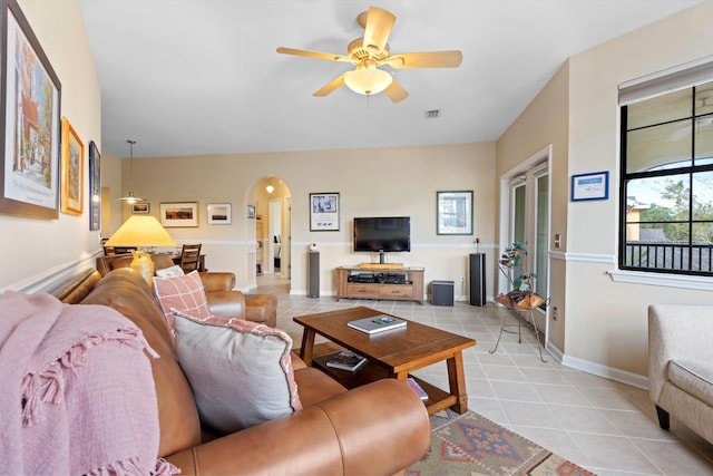 living room featuring light tile patterned flooring and ceiling fan