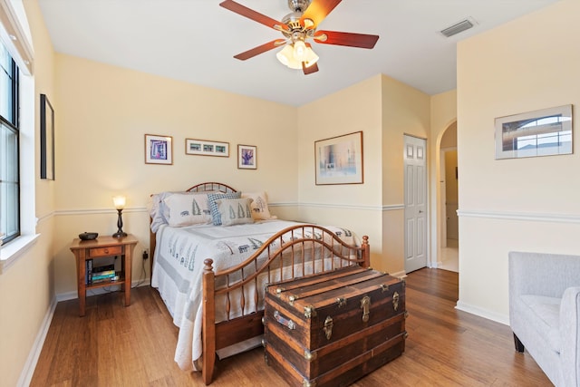 bedroom with hardwood / wood-style floors and ceiling fan