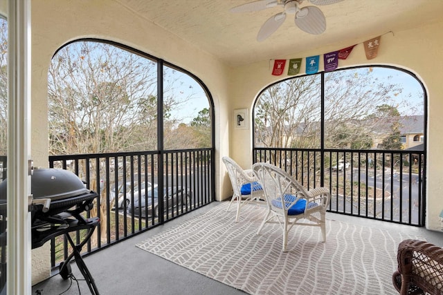 sunroom featuring ceiling fan