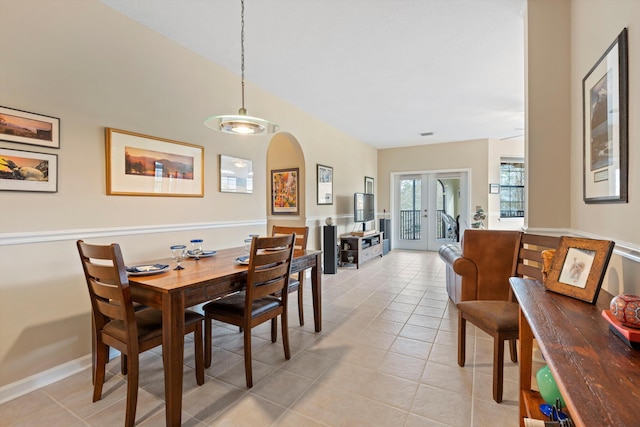 dining area with french doors and light tile patterned flooring