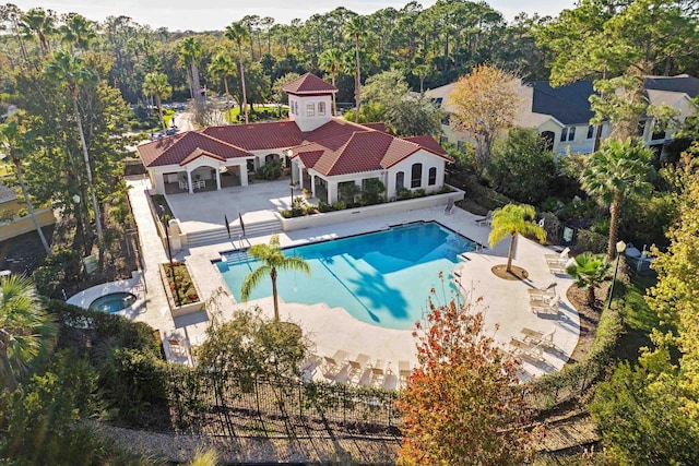 view of pool with a patio and an in ground hot tub