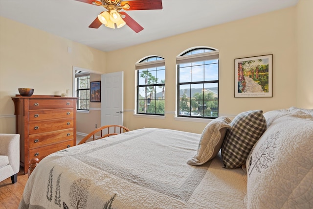 bedroom featuring wood-type flooring and ceiling fan