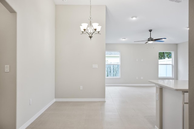 interior space featuring ceiling fan with notable chandelier and light tile patterned floors