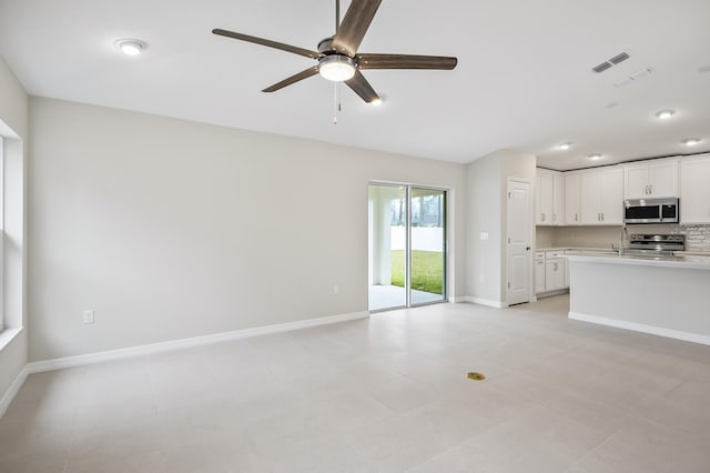 unfurnished living room with ceiling fan