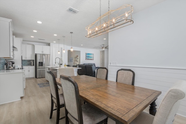 dining space featuring light wood finished floors, visible vents, and recessed lighting