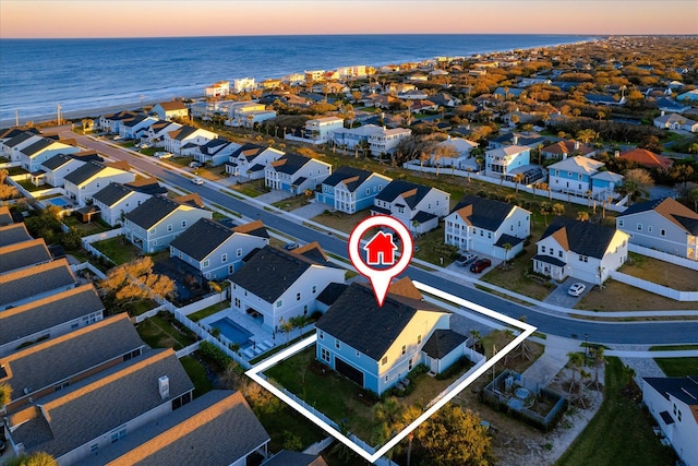 drone / aerial view with a water view and a residential view