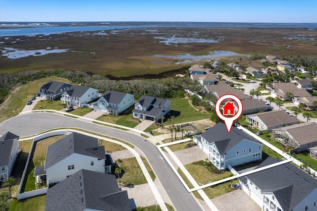 birds eye view of property featuring a water view and a residential view