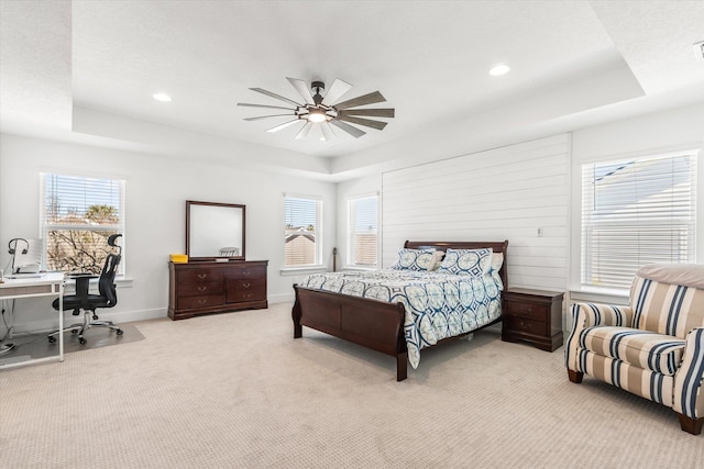 bedroom featuring multiple windows, carpet flooring, a tray ceiling, and recessed lighting