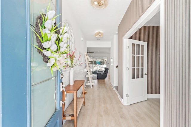 entryway with baseboards, light wood-style flooring, and wallpapered walls
