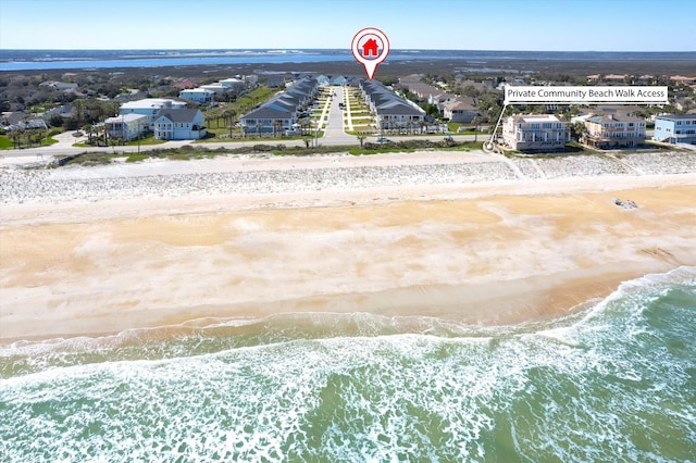 birds eye view of property featuring a water view and a view of the beach