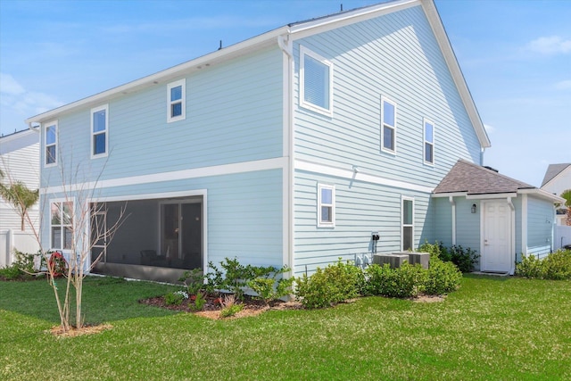 back of property with a lawn