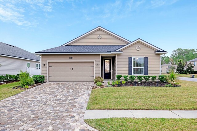 ranch-style home featuring a garage and a front lawn