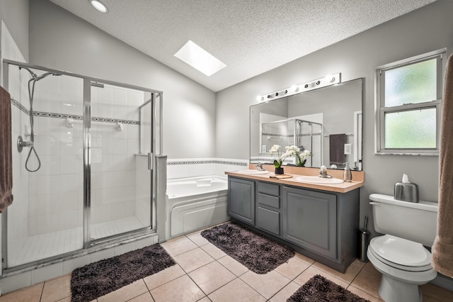 full bathroom featuring tile patterned flooring, separate shower and tub, lofted ceiling with skylight, and a textured ceiling