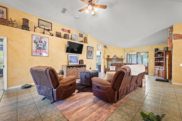 living room with ceiling fan, tile patterned flooring, and high vaulted ceiling