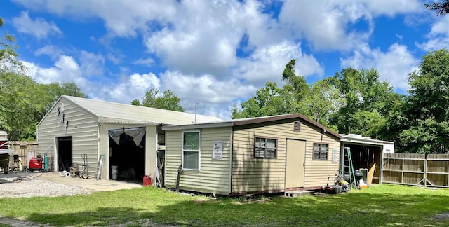 view of outdoor structure featuring a yard and a garage