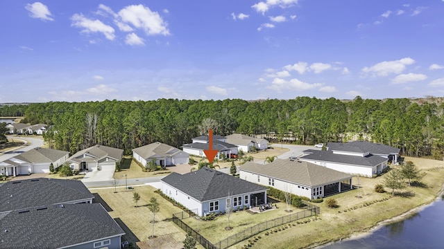 bird's eye view featuring a wooded view and a residential view