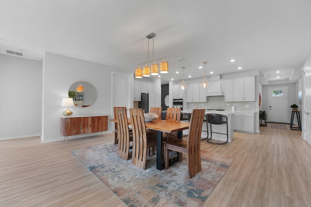 dining space with light wood-type flooring, visible vents, baseboards, and recessed lighting