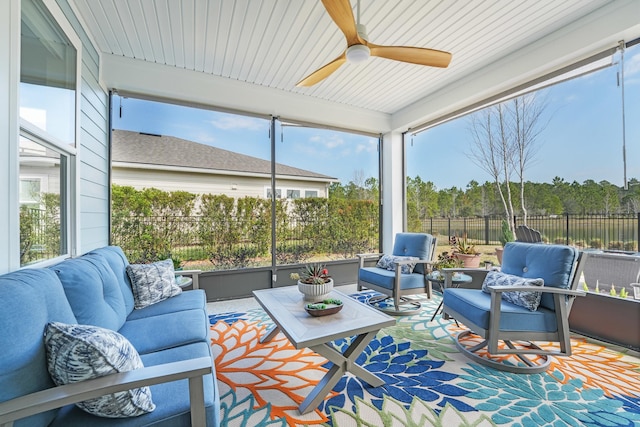 sunroom / solarium featuring a healthy amount of sunlight and ceiling fan